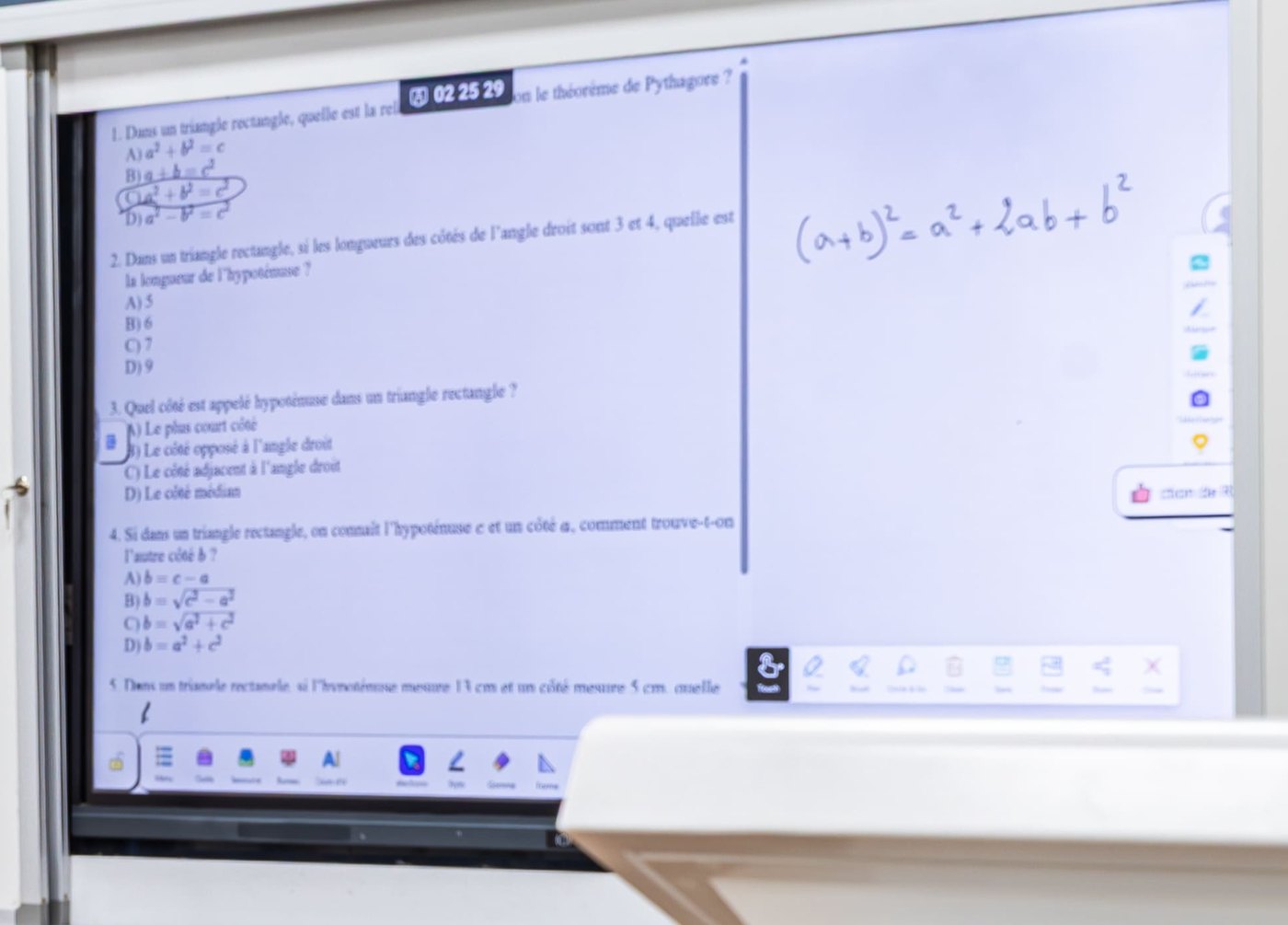 L’écran interactif, avec un cours de mathématiques annoté à la main.